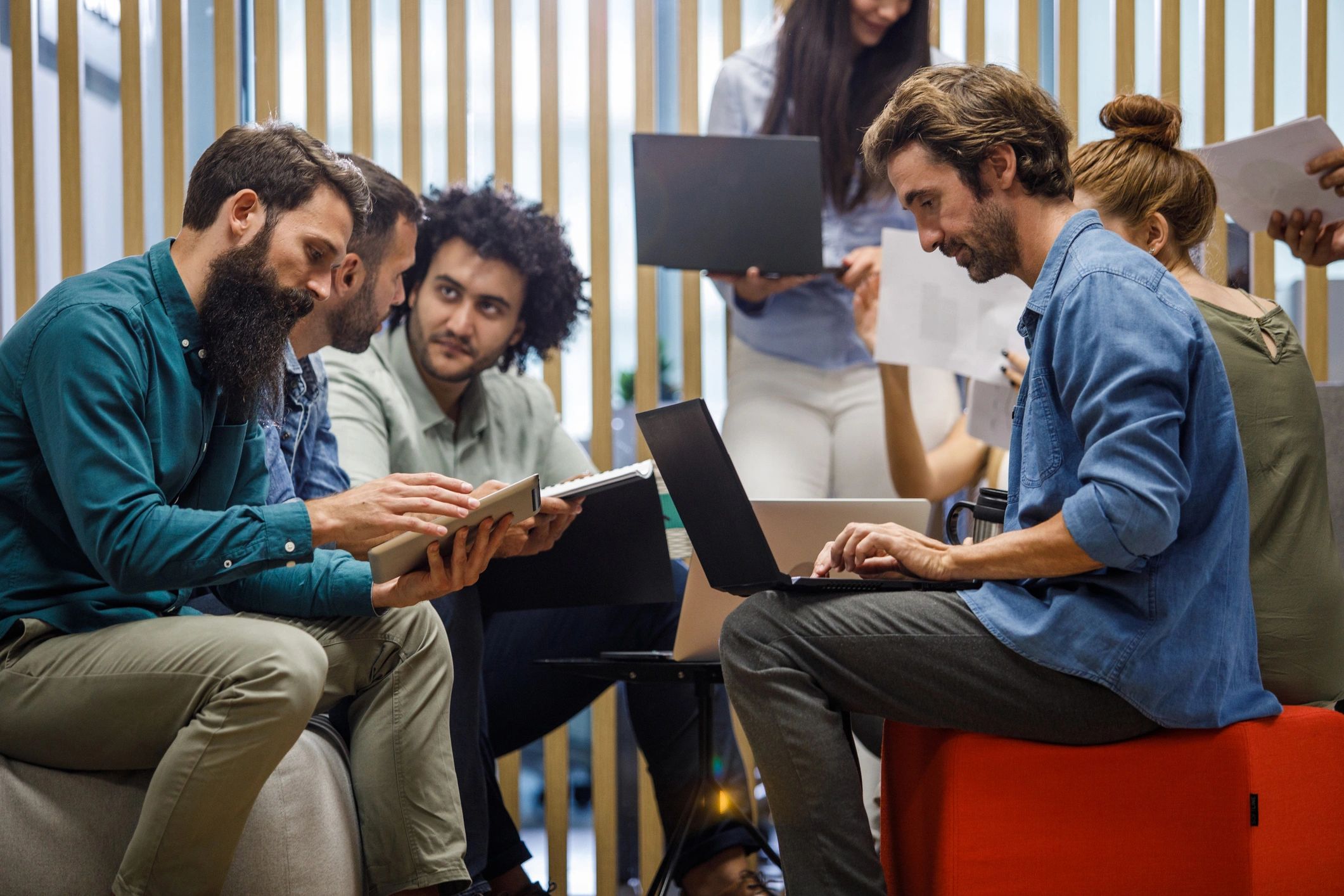 Founders collaborating with laptops and notes