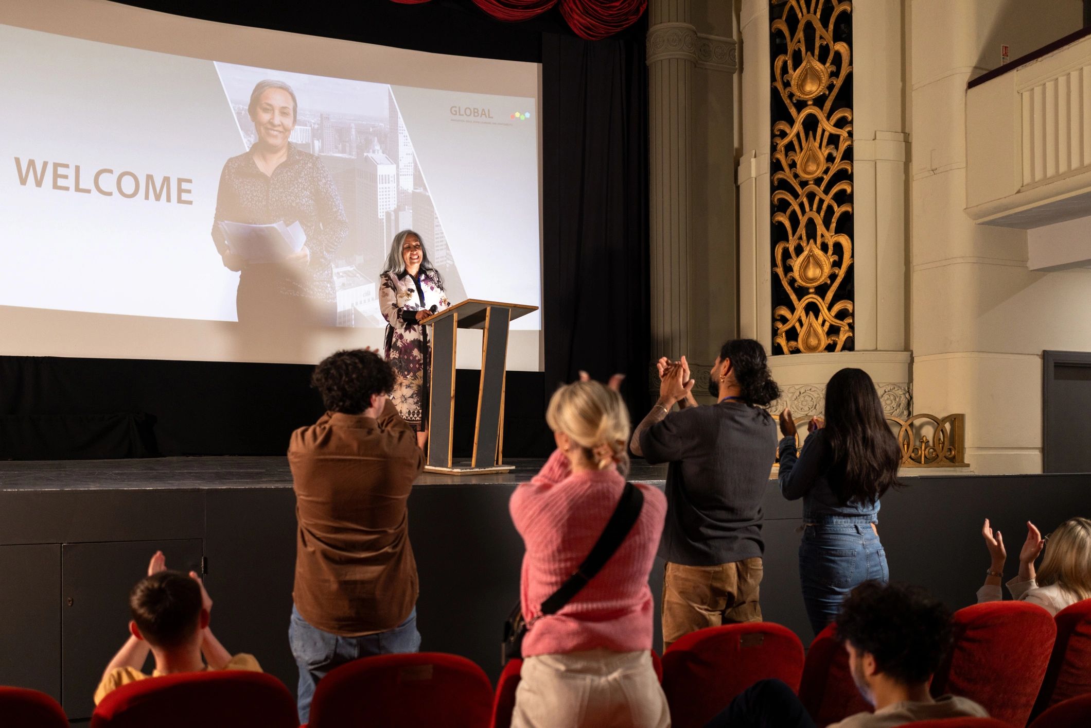 Speaker presenting on stage at a business conference