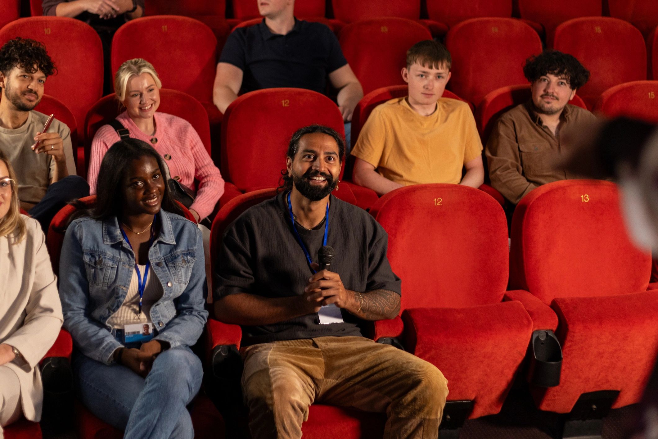 Audience member asking a question during a conference